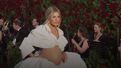 Pregnant Sienna Miller bares baby bump in billowing couture at Vogue World:  London