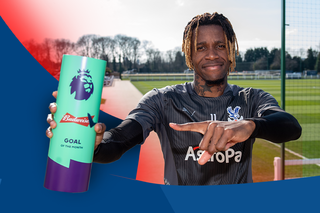 Wilfried Zaha receives his medal for scoring 50+ Premier League goals